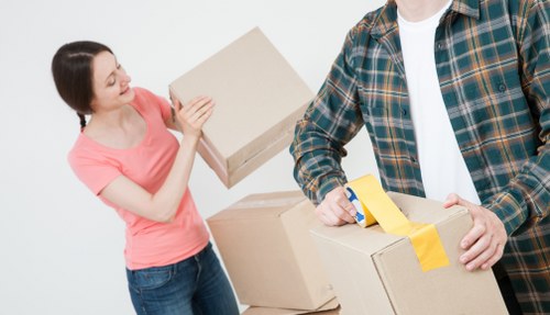 Furniture removals team handling a sofa move in an Enfield home
