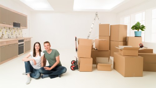 Team handling office equipment during a relocation in Enfield