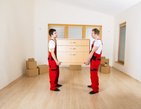 Commercial removal team preparing office equipment for transport